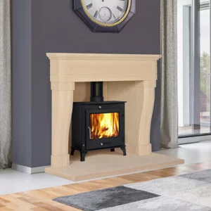 Large white stone fireplace with black log burner fire, Feature clock above fireplace, grey rug on floor, Sandridge Stone Fireplaces, Limestone, Bath Stone, Portland Limestone, Melksham, Wiltshire